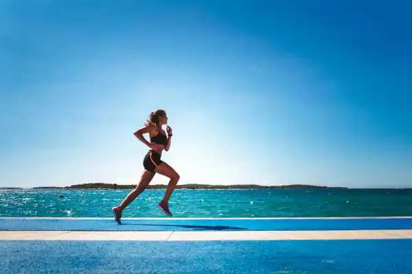 Woman running showing strong leg muscle Leighton Buzzard